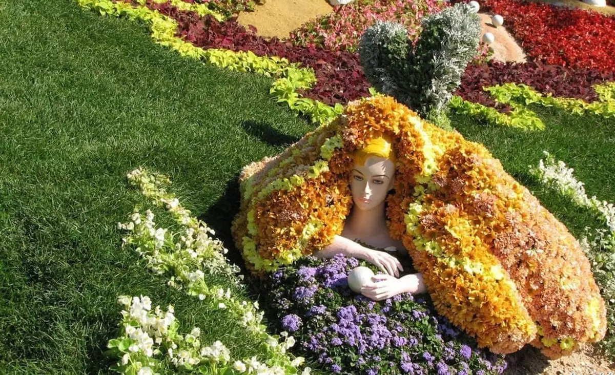 Mannequin in flowerbed